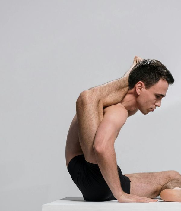 A person demonstrating strength and flexibility in an advanced yoga pose.